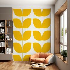 an orange chair sitting in front of a yellow flowered wallpaper on a living room wall