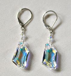 "These stunning Swarovski clear crystal AB sterling silver earrings are handcrafted by me. Perfect 15th crystal anniversary gift for wife or 50th birthday! These are a must have for the crystal lover! These earrings are handcrafted by me using Crystal AB De-Art Swarovski crystals. I wire-wrapped a smaller Crystal AB bicone between the larger crystal and the ear wire. The larger crystals are 18mm and the earring hangs approximately 1\" from the sterling silver ear wire. The AB or aurora borealis Crystal Earrings With Sparkling Stones For Anniversary, Crystal Drop Earrings For Anniversary, Clear Crystal Earrings As A Gift, Clear Crystal Earrings For Gift, Sparkling Sterling Silver Crystal Earrings For Anniversary, Nickel-free Crystal Earrings For Formal Occasions, White Sparkling Crystal Earrings For Anniversary, Crystal Earrings For Celebration, Formal Nickel-free Crystal Earrings