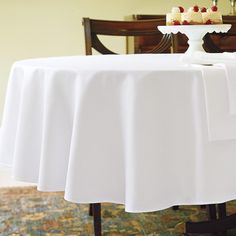 a white table topped with a cake covered in frosting