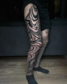 a man with tattoos on his legs and leg