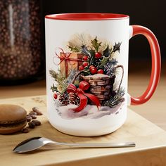 a red and white coffee mug sitting on top of a wooden table next to a spoon