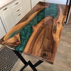 a table that has been made to look like a river in the woods with blue water