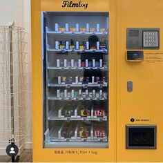 a yellow vending machine with drinks and sodas in it's display case