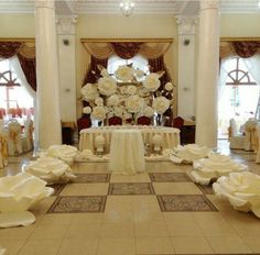 a room filled with tables covered in white flowers