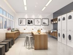 a large laundry room with washers and dryer in the wall next to each other