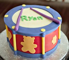 a birthday cake with a drum and name on it