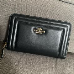 Coach Leather Black Wallet With Gold Accents. Never Used. Formal Black Wallet With Zipper Closure, Chic Coach Bifold Wallet, Chic Black Bifold Wallet, Formal Black Coach Wallet, Coach Black Evening Wallet, Coach Black Wallets With Card Slots, Coach Leather Clutch With Card Slots, Black Coach Wallets With Card Slots, Chic Coach Wallet With Zipper Closure