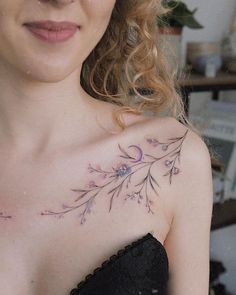 a close up of a woman's chest with flowers on it