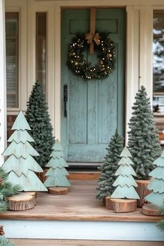 christmas trees are sitting on the front porch