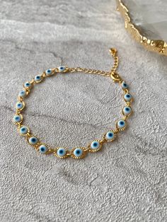 🧿 Stunning handmade White Evil eye jewellery, available, crafted from tarnish resistant stainless steel 🧿. This bracelet will fit any wrist size as its adjustable. The evil eye is a protective and powerful symbol, also known as the Nazar. The evil eye helps to absorb negative energies, protect and bring luck. The evil eye makes a perfect gift for yourself and loved ones.  Hand of Fatima Necklace https://www.etsy.com/uk/listing/1556603231/hamsa-hand-of-fatima-gold-pendant?click_key=a6f5da90d8d8ea8bd774c20becf761f1cd89bc53%3A1556603231&click_sum=a9a084e9&ref=shop_home_active_3 Hand of Fatima Earrings https://www.etsy.com/uk/listing/1542499652/hamsa-hand-of-fatima-gold-stud-earrings?click_key=89cabcb8ef68040716616f6d3e33732975d65ab1%3A1542499652&click_sum=5e820e7d&ref=shop_home_active_1 💎J Hand Of Fatima, Eye Make, Evil Eye Bracelet, Hamsa Hand, Evil Eye Jewelry, Gold Studs, Gold Earrings Studs, Evil Eye, Chain Link Bracelet