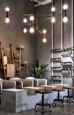 the interior of a hair salon with chairs and stools in front of shelves full of books