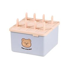 a blue and white box with wooden pegs on it's lid that says dear little bear