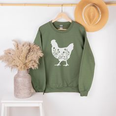 🐔This Chicken Sweatshirt or Hoodie is the perfect gift for everyone! Your orders made with the highest quality materials and are super soft, comfy and cozy!! 🐔 🟢HOW TO ORDER 🟢 1. Check and Review ALL Photos 📷 2. Select Your Sweatshirt/Hoodie Size and T-Shirt Color from drop down menus ✨ 3.Select Your Design Print Color from images and mention in personalization section 🎨 4. Add to cart & place order 🛒 We're constantly striving to provide excellent service. We'd love to get your feedback : Farm Animal Prints, Chicken Sweatshirt, Floral Chicken, Sweatshirt Graphic, Chicken Shirts, Lover Sweatshirt, Animal Sweatshirt, Farm Birthday, Chicken Lovers