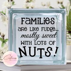 a glass block that says families are like fudge mostly sweet with lots of nuts