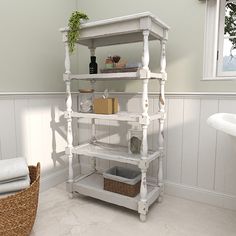 a white shelf in the corner of a bathroom