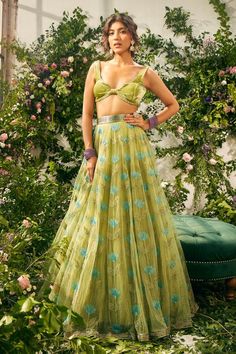 Green attached cancan lehenga with resham embroidery in flower pattern. Paired with bead embellished velvet padded blouse and tassel dupatta.
Components: 3
Pattern: Embroidery, Embellished
Type Of Work: Resham, flower, bead
Neckline: Leaf neck
Sleeve Type: Sleeveless
Fabric: Tulle, Silk Organza, Silk Velvet
Color: Green
Other Details: 
Lehenga Length: 45 inches
Inverted V hem
Back tassel tie-up
Tassel bordered sheer dupatta
Occasion: Wedding - Aza Fashions Flower Lehenga, Cancan Lehenga, Neck Flower, Resham Embroidery, Tulle Embroidery, Green Tulle, Padded Blouse, Manish Malhotra, Embroidered Lehenga