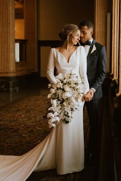 the bride and groom are posing for a photo