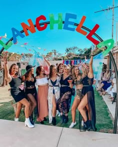 a group of young women standing next to each other under an arch with the word gangiel on it