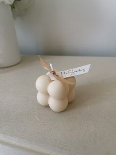 a white vase filled with flowers on top of a table