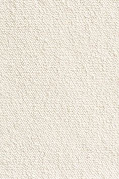 a white textured wallpaper background with some small dots on the top and bottom