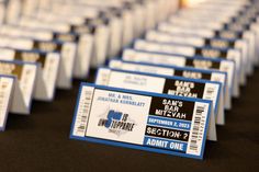 some tickets sitting on top of a table with black and white labels in front of them