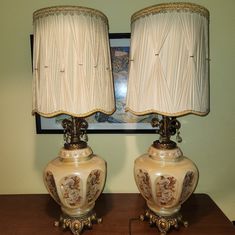 two lamps sitting on top of a wooden table