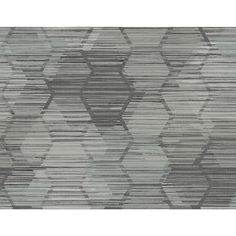 a gray and white rug with an abstract design on the bottom, in shades of grey