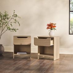 two wooden side tables sitting next to each other on top of a hard wood floor