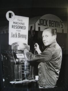 a black and white photo of a man working on an old fashioned jack bunny machine