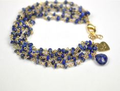 Six strands of lapis lazuli. 18kt gold plate over sterling silver. 6 3/4 inch fit length with 1 inch extender chain. Gold Lapis Lazuli Bracelet With Gemstone, Gold Bracelets With Lapis Lazuli And Natural Stones, Gold Lapis Lazuli Gemstone Bracelet, Gold Lapis Lazuli Bracelets For Gift, Gold Lapis Lazuli Spiritual Bracelets, Artisanal Design, Lapis Lazuli Bracelet, Smoky Topaz, Stone Wrapping