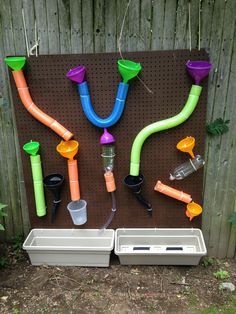 there are many different types of pipe holders on the pegboard, and one is filled with water