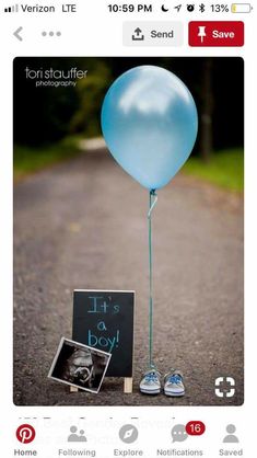 a blue balloon is tied to a chalkboard with the word it's a boy written on it