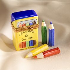 several crayons and a box of colored pencils