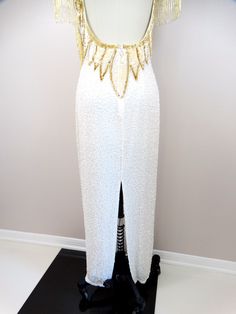 "This is a stunning gown heavily embellished with glass beading and sequins. This one is incredibly amazing! It's in perfect condition! Measurements: * Bust - 34\" * Waist - 27\" * Hips - 38\" * Length - 55\" * Tag Size - Small (please refer to measurements) All of my items come from a smoke-free and pet-free home. If you would like more information or have any questions, please don't hesitate to ask!" White Beaded Fitted Evening Dress, White Fitted Beaded Evening Dress, Fitted White Beaded Evening Dress, White Embellished Evening Dress For Reception, White Embellished Sequin Dress For Wedding, White Beaded Sequin Fabric For Evening, White Hand Embellished Evening Gown, White Hand Embellished Fitted Gown, Hand Embellished White Party Gown