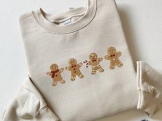 Embroidered Gingerbread Cookies Sweatshirt, Gingerbread Christmas Embroidered Sweatshirt, Christmas Sweatshirt, Funny Christmas, Xmas Gift, CozyGenZ This Embroidered Gingerbread Cookies Sweatshirt is a must have for the holiday season! What's better than looking cute and warm in the colder months during Christmas. Our crewnecks are made from the highest quality fabric for an incredibly soft and comfortable fit, with advanced printing to ensure that the colors and graphics are vibrant and detailed. ❤ If you want to order matching shirts, add each item separately by choosing different colors and sizes each time, and add each one into your cart. ❤ Sizes run from Small to XXL (2XL). This unisex sweater is intended to be oversized and loose-fitting for women for a chic and laid-back vibe. If yo Cheap Christmas Letter Print Sweatshirt, Cheap Christmas Sweatshirt For Gift, Cheap Christmas Sweatshirt As Gift, Cheap Christmas Sweatshirt Gift, Cheap Christmas Sweatshirt As A Gift, Christmas Embroidered Sweaters 2022, Affordable Cotton Christmas Sweatshirt, Christmas Letter Print Sweatshirt, Gingerbread Sweatshirt