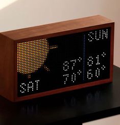 a wooden clock sitting on top of a table