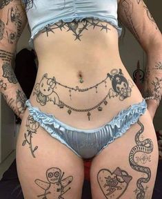 a woman with many tattoos on her stomach and butts, showing off her panties