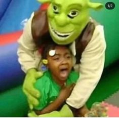 a young child is being hugged by an alien