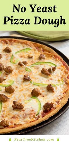 no yeast pizza dough with sausage and zucchini on it in a black pan