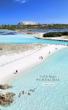 an aerial view of people walking on the beach in front of blue water and white sand