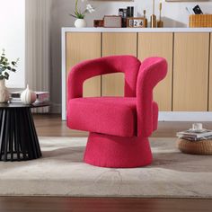 a pink chair sitting on top of a wooden floor