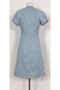 Versatile denim dress featuring a classic semi flared silhouette. The perfect dress to wear to a picnic at the park, pair it with chic sandals and a statement handbag. Size 4 Lined, cotton & elastane blend V-neckline Short sleeves Unlined Flared silhouette Mustard top stitching Above knee Bust 34" Waist 28" Shoulder to hem 37" Classic Fitted Denim Dress, Elegant Short Sleeve Denim Summer Dress, Medium Wash Cotton A-line Denim Dress, Classic Medium Wash Denim Dress For Spring, Classic Blue Denim Dress For Spring, Spring Denim Blue Workwear Denim Dress, Classic Knee-length Spring Denim Dress, Classic Denim Dress For Workwear In Spring, Classic Spring Denim Dress For Work