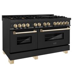 a black stove with gold knobs and two oven doors