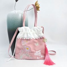 Spring Embroidered Cotton Shoulder Bag, Spring Cotton Shoulder Bag With Floral Embroidery, Pink Fabric Shoulder Bag For Spring, Spring Pink Fabric Shoulder Bag, Pink Handheld Embroidered Shoulder Bag, Spring Handheld Embroidered Shoulder Bag, Handheld Embroidered Shoulder Bag For Spring, Spring Embroidered Handheld Shoulder Bag, Traditional Bags With Floral Embroidery For Spring