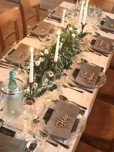 the table is set with silverware and place settings