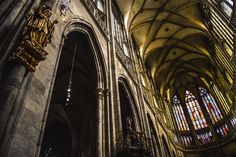 the interior of an old cathedral with stained glass windows