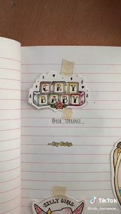 an open notebook with stickers on the pages and some words written in it to spell out girly baby