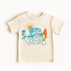 The Big One Shirt, Custom 1st Birthday Shirt, Surf Birthday tee, Surfs Up, Surfer Ocean Wave tee **HOW TO ORDER** 1. Select the color and size/name from the drop-down menu and add it to the cart 2. Repeat the process if you want to order more shirts **SIZE CHART** Please scroll through the listing photos to see the size charts. **DESIGN SPECIFICS** We print our shirts using Direct To Garment printing technology. process which makes the design naturally blend into the fabric, making it very soft to touch.  **SHIRTS** white and natural are 100% cotton **PROCESSING TIME** Made to Order Please allow 1-5 business days for your order to be completed.PLUS SHIPPING TIME . **SHIPPING TIME** Depends on the shipping method chosen and destination, but in general after the order is placed, the package Graphic Tee For First Birthday With Short Sleeves, First Birthday Graphic Tee With Short Sleeves, First Birthday Graphic Tee With Name Print, Graphic Tee With Name Print For First Birthday, First Birthday Graphic Tee With Crew Neck, Short Sleeve Shirt For First Birthday In Summer, Graphic Print Shirt For First Birthday In Summer, Summer Graphic Print Shirt For First Birthday, First Birthday Summer T-shirt With Crew Neck