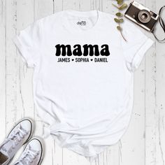 "Looking for a custom-made t-shirt to show off your love for your little ones? Look no further than our custom \"Mama\" shirt, featuring your choice of personalized names! Crafted with the highest-quality materials, our custom mama shirt is the perfect way to show off your unique bond with your children. Each shirt is made to order, with your choice of up to three names expertly printed onto the front. Not only is our custom mama shirt stylish and comfortable, but it also makes for the perfect gift for any proud mom. Whether you're looking to treat yourself or surprise a loved one, our shirt is sure to be a hit. And with our easy-to-use online ordering system, getting your hands on your very own custom mama shirt has never been easier. So why wait? Order yours today and show off your love Family Matching Cotton T-shirt Gift, Cotton Crew Neck T-shirt For Family Events, Funny Short Sleeve T-shirt For Family Events, Funny Family Cotton T-shirt, Funny Cotton T-shirt For Family, Father's Day White T-shirt With Custom Print, Custom Print Cotton T-shirt For Family, White Letter Print T-shirt As Gift, Cotton Graphic Print Top For Family Events