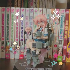 an anime figurine sitting on top of a table in front of a bunch of books